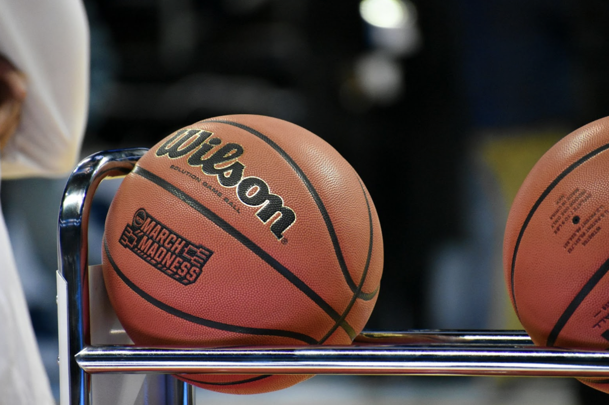 Basketball with March Madness logo sitting on a rack.